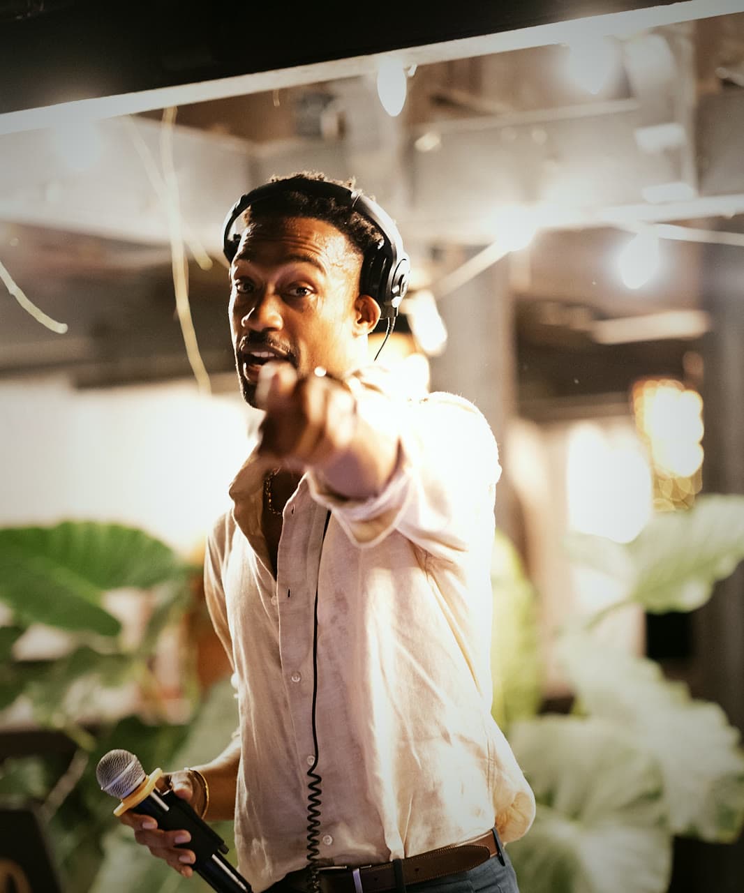 DJ Keybo on the mic, pointing to the crowd